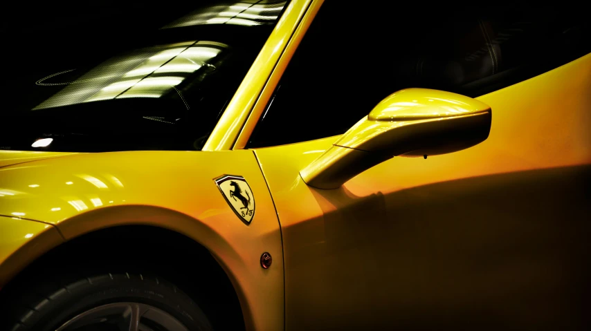 a close - up view of the front wheel drive of a yellow sports car