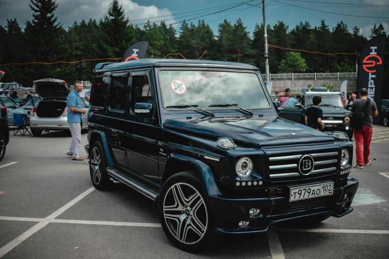 black mercedes g wagon parked at curbside of park