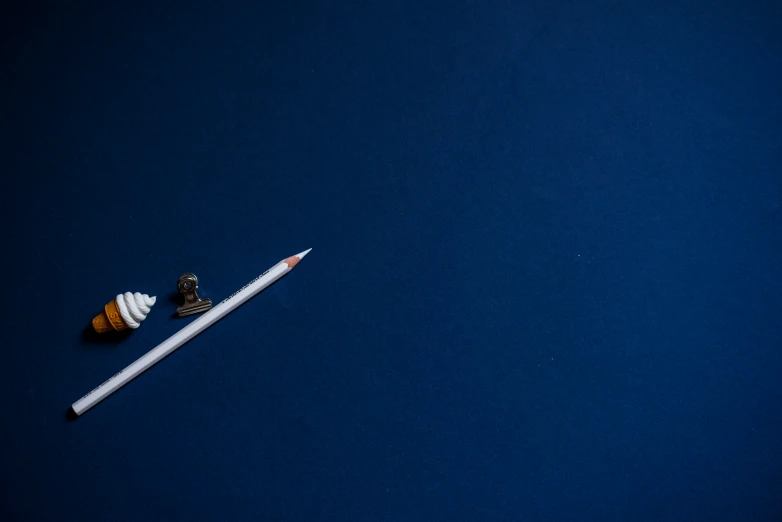 a pencil is laying on a dark surface