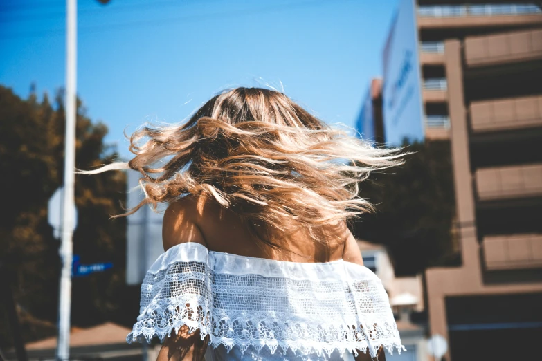 a woman's head with the wind in her hair