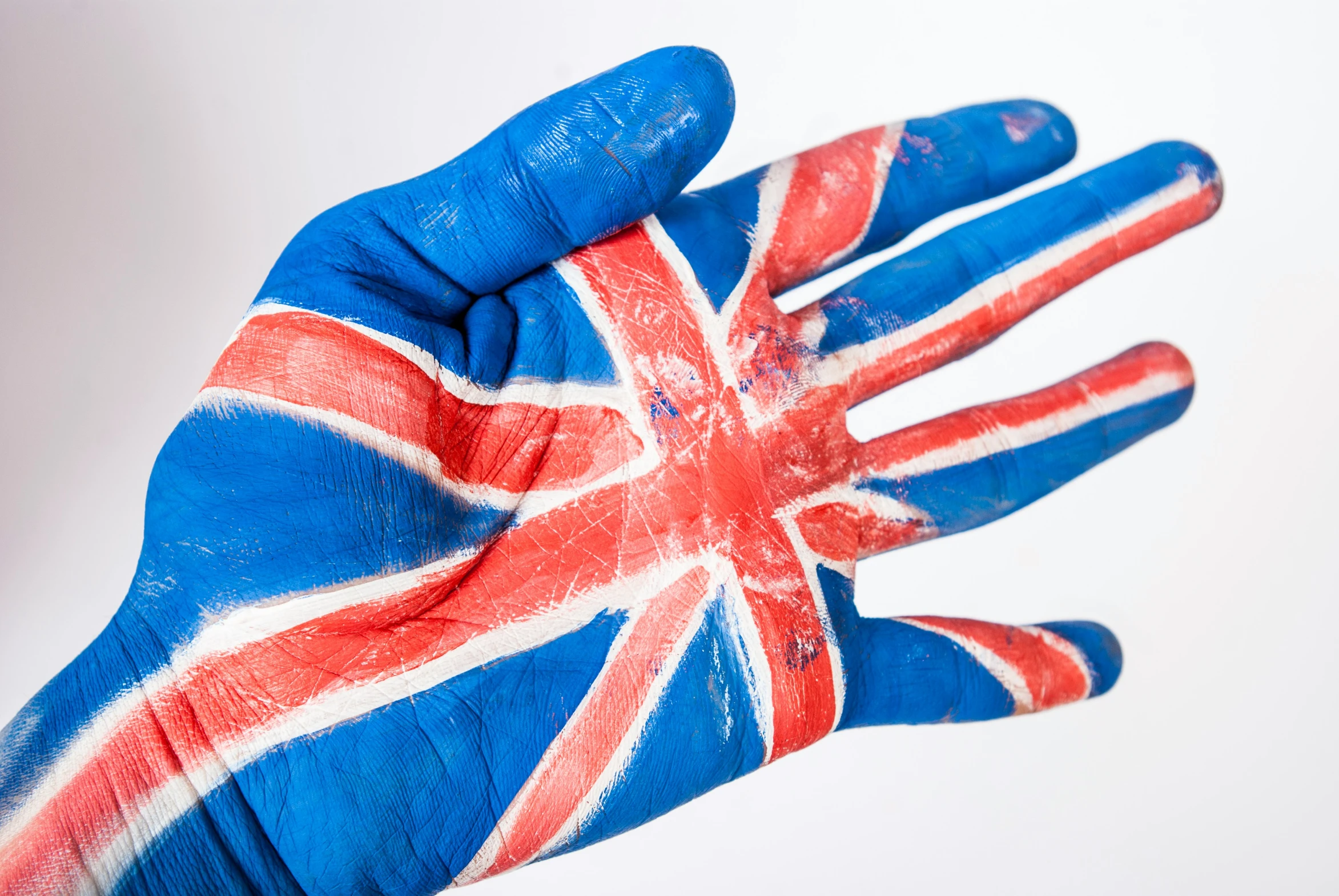 a blue and white painted hand is next to a red white and blue wall