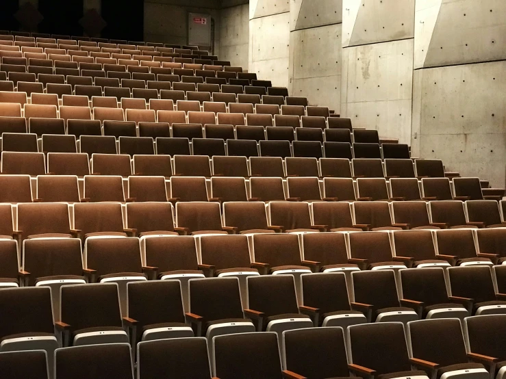 several rows of seats sitting in front of a wall