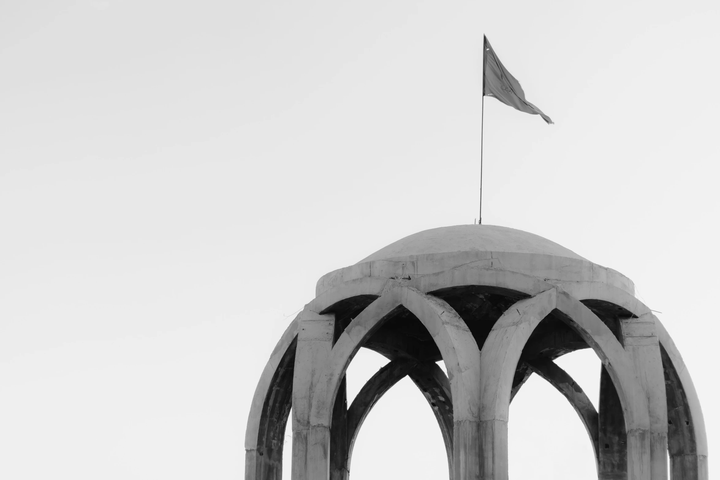 a small black and white flag on top of a monument