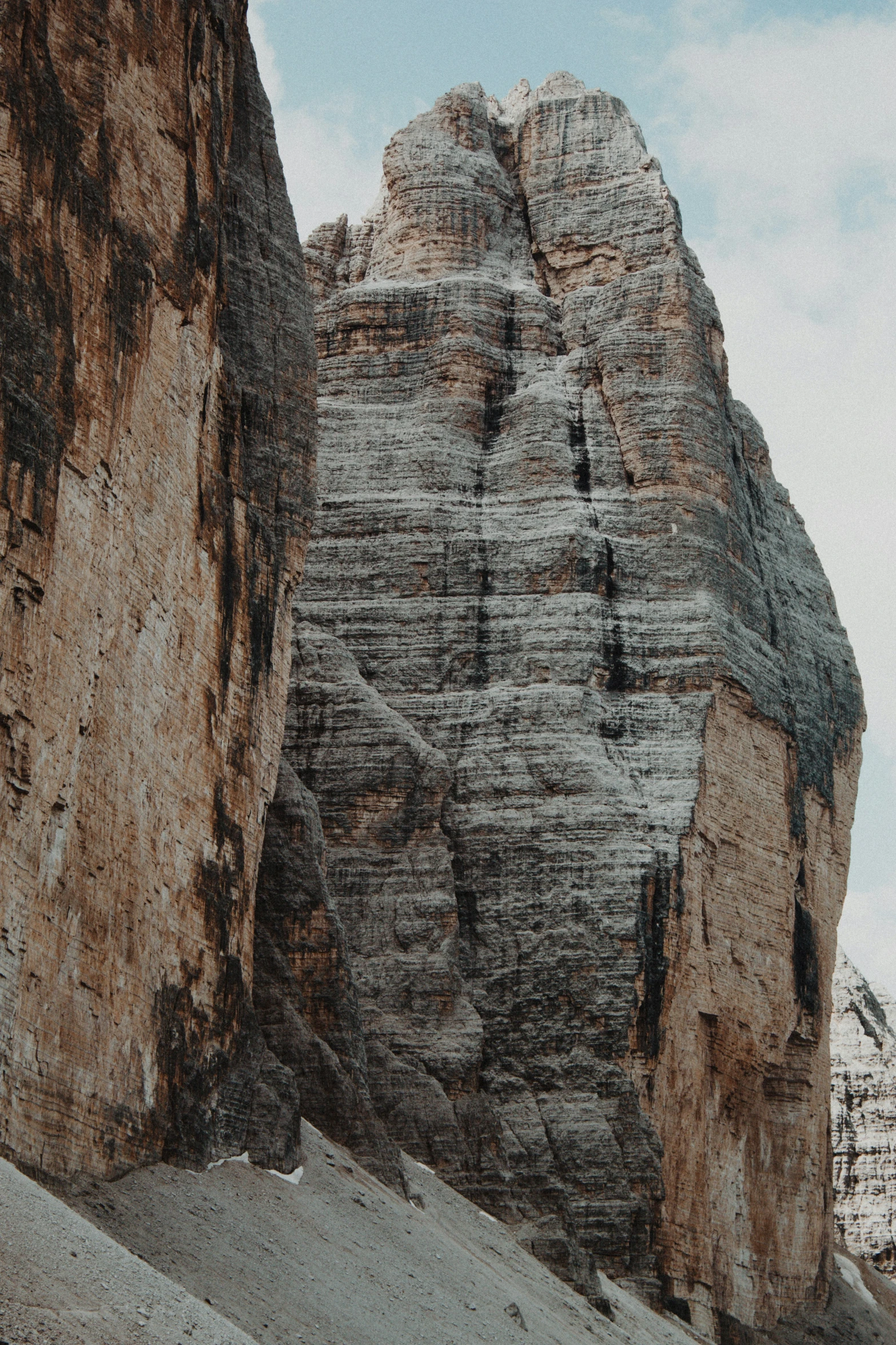 several large rocks against the sky in front of a building