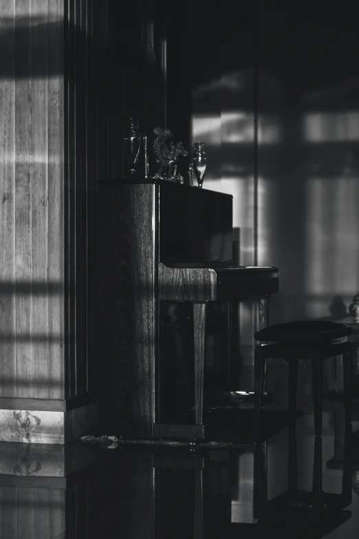 an empty piano next to some wooden stools