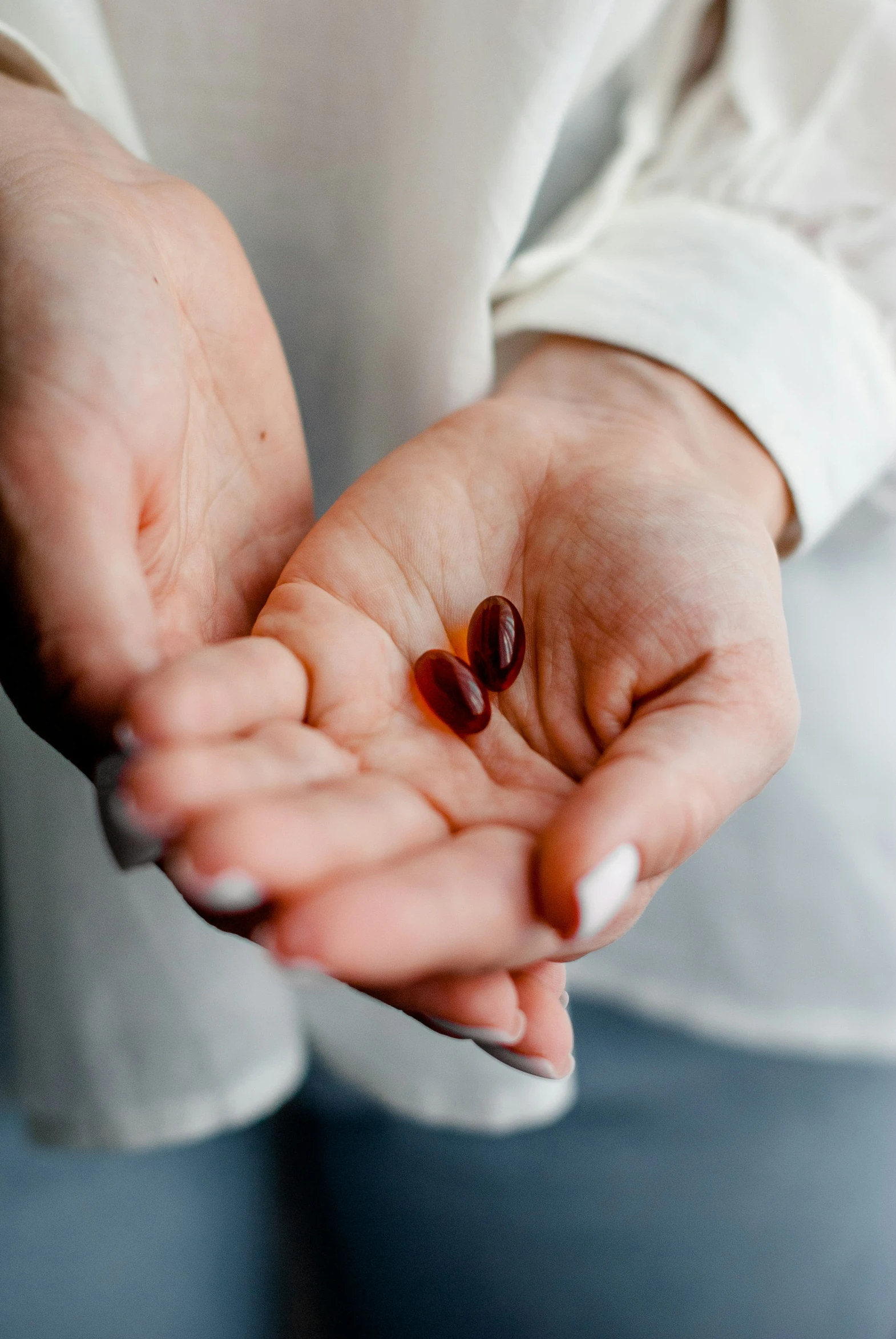 a person holds out their hands with an object in the palm