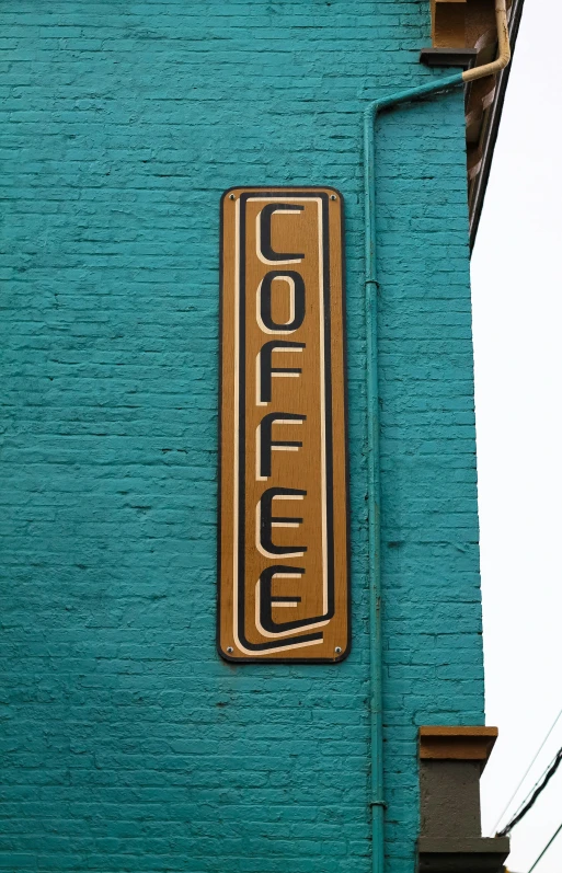 the side of an older building with a wooden plaque