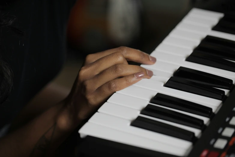 someone is playing the piano with their hands