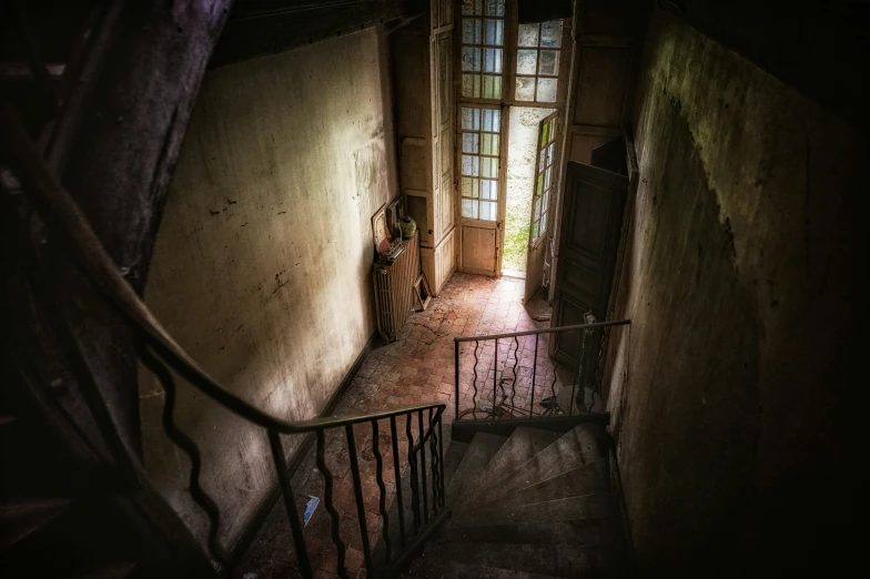 the dark stairway of an old house, is dim lit
