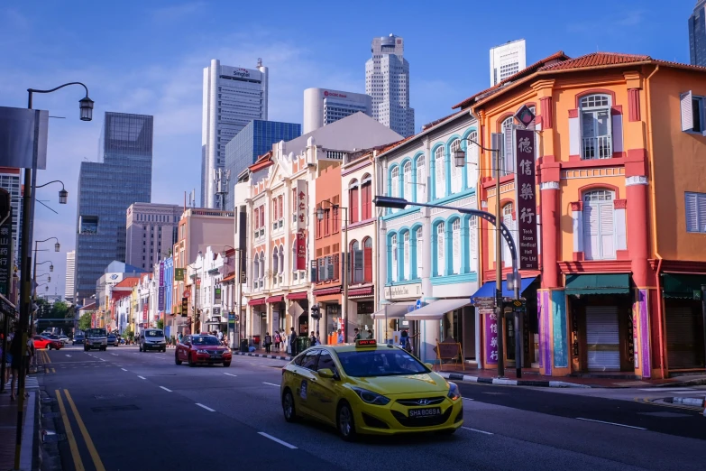 a yellow car in front of an empty street