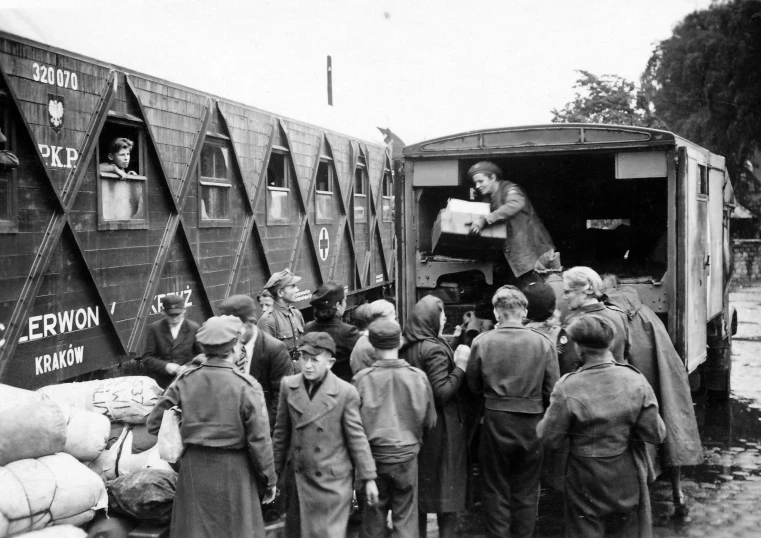 an old black and white po of people exiting a train