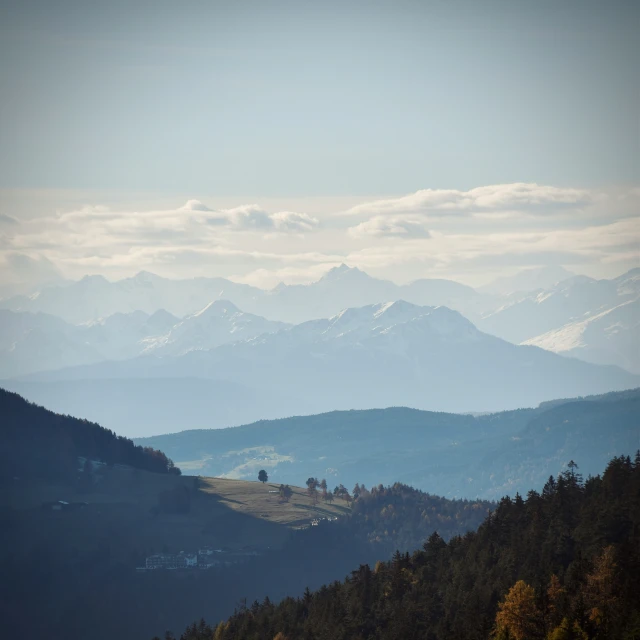 the mountains are covered in snow as they sit behind