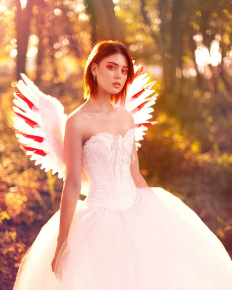 a woman is standing in the woods wearing an angel costume