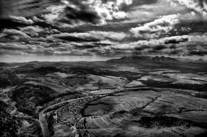 black and white landscape of an expanse of land and mountains