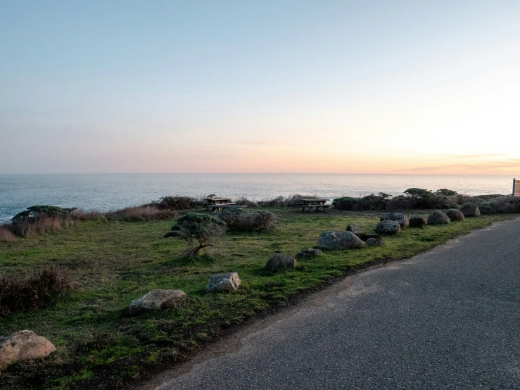 a very big road by the water and some grass