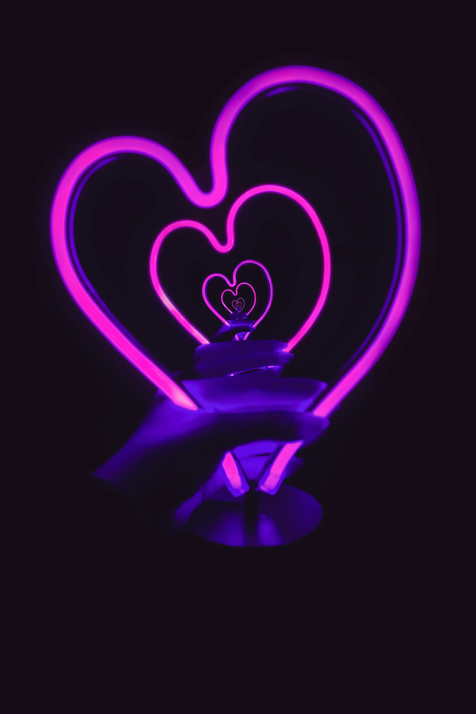 neon hearts are lit up to look like they are in the air