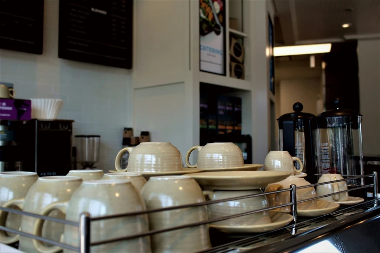 coffee pots and teacups on display for sale in store