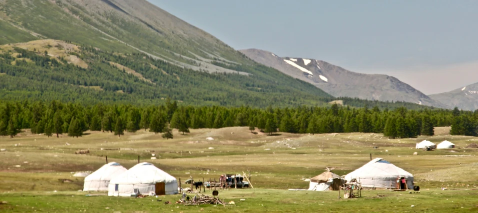 some people standing outside of some tents