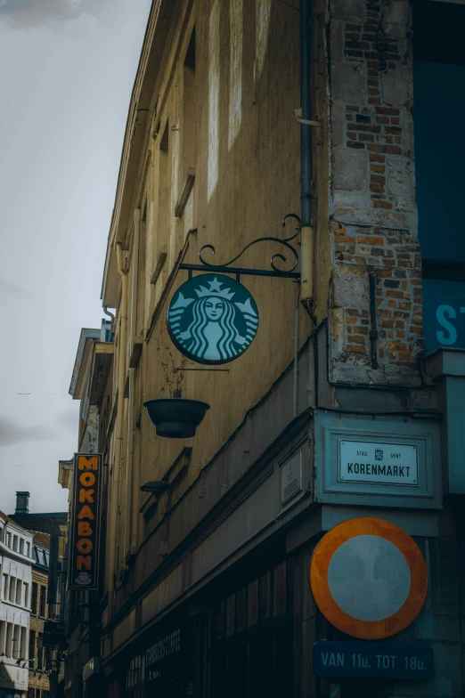 the side of a large brick building with a coffee sign