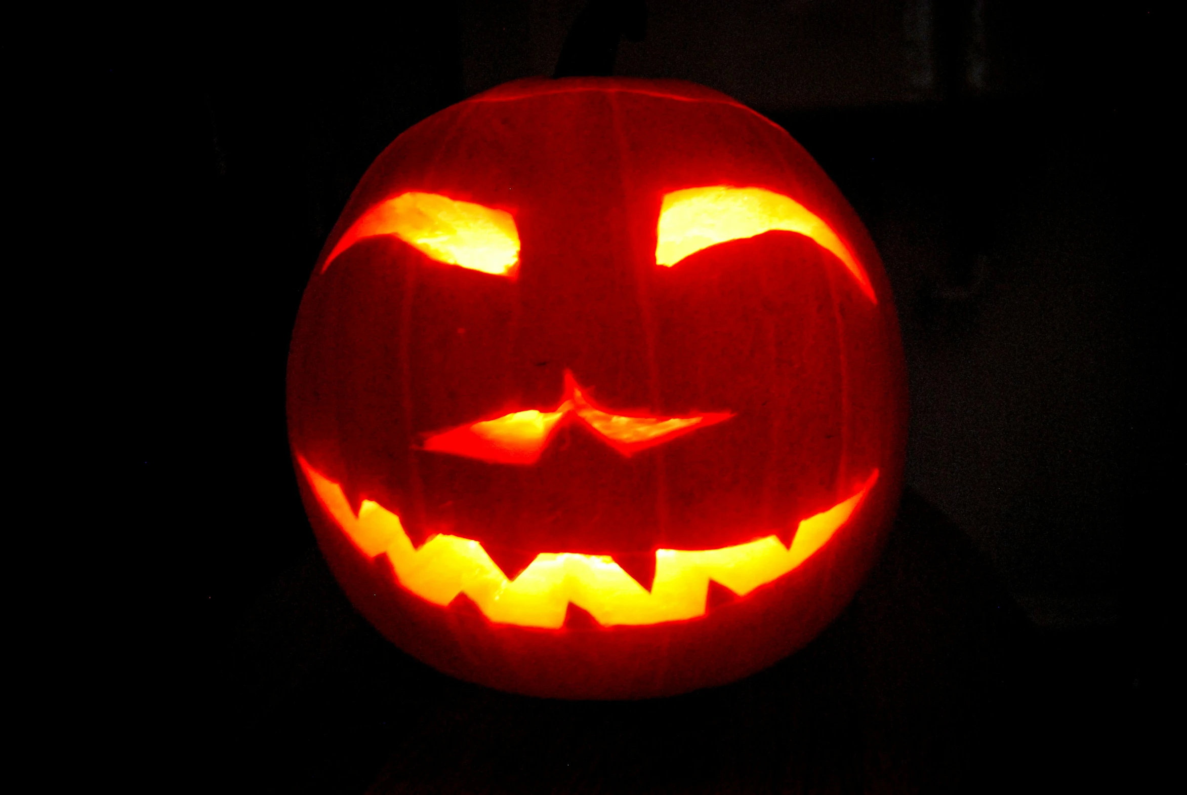a carved halloween pumpkin in the dark