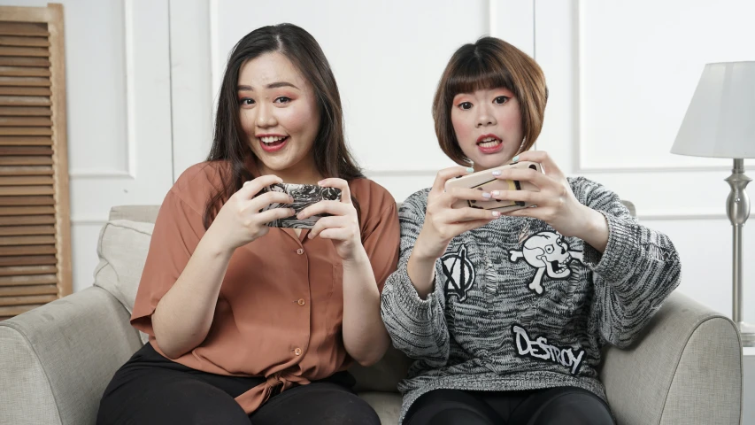 two girls are playing wii in the room