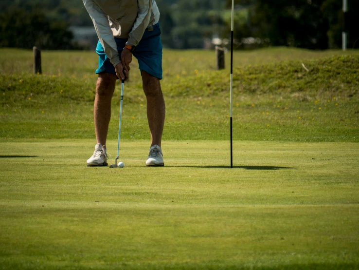 a person prepares to hit the golf ball