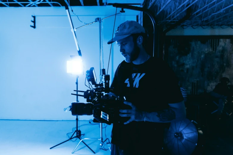 a man with a camera and lights behind him