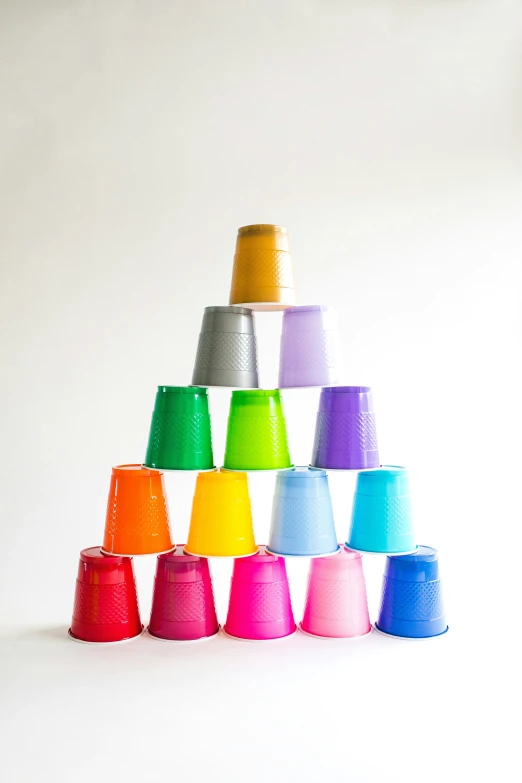 the brightly colored cups are piled up