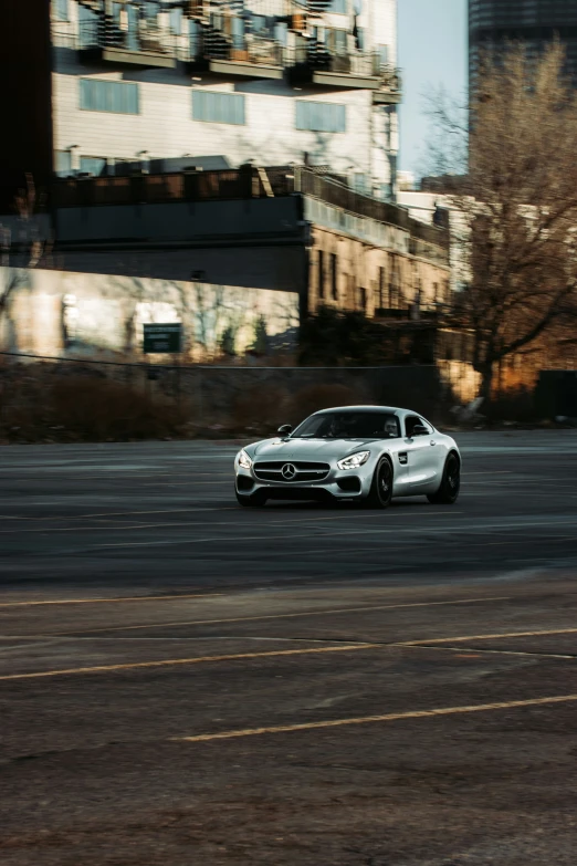 the front end of a sports car on an asphalt street