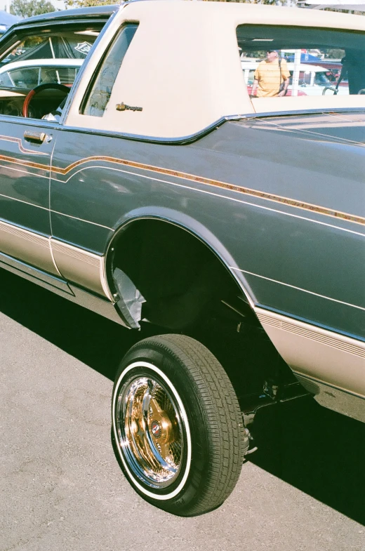 a black car is parked in the sun