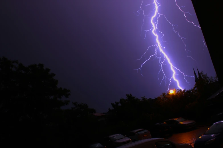 a very bright purple lightning with the building lit up