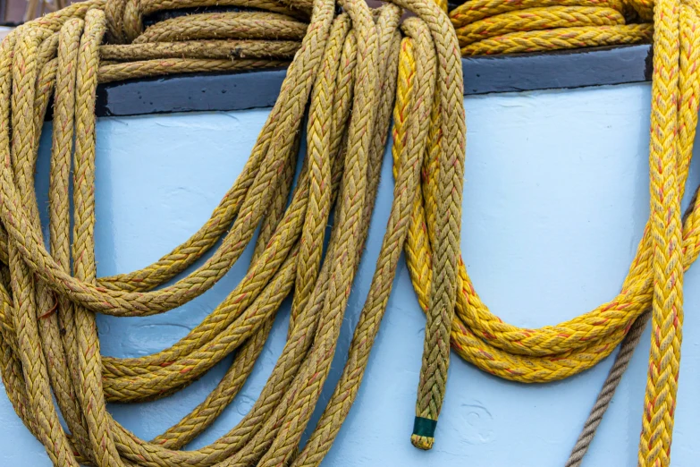 yellow rope against the blue wall of a boat