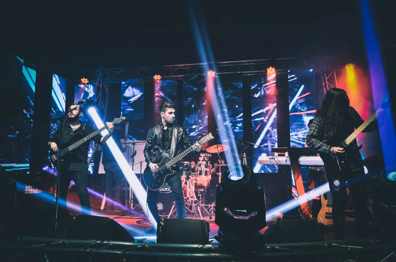 a band plays on stage on a black background