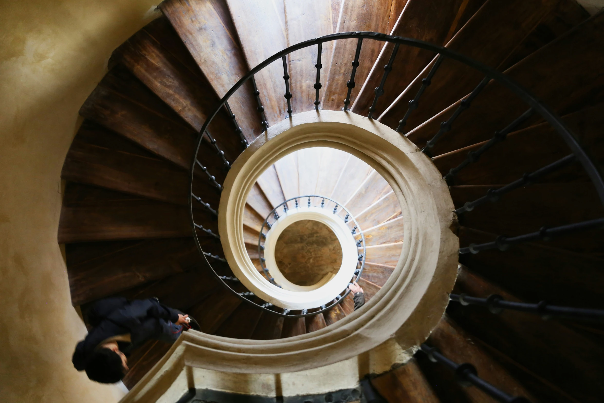 man walking down stairs to a second story