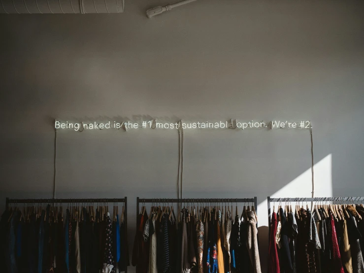 an interior view of a clothing shop with several ties on hangers