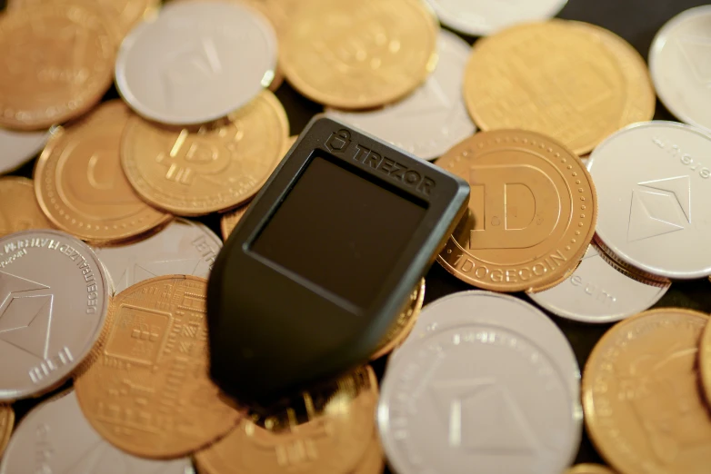 an electronic device is on top of a pile of coins