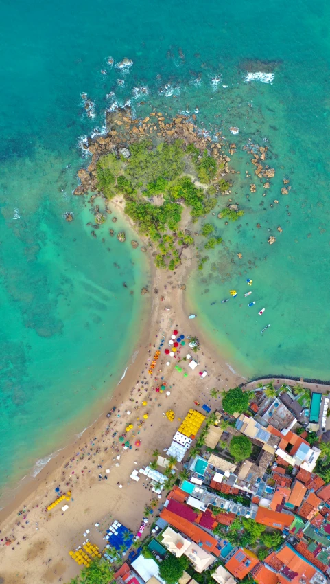 a very pretty beach in the middle of a blue ocean