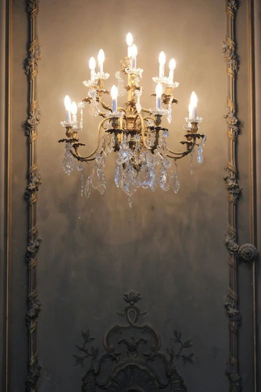 ornate chandelier hanging in room with white walls