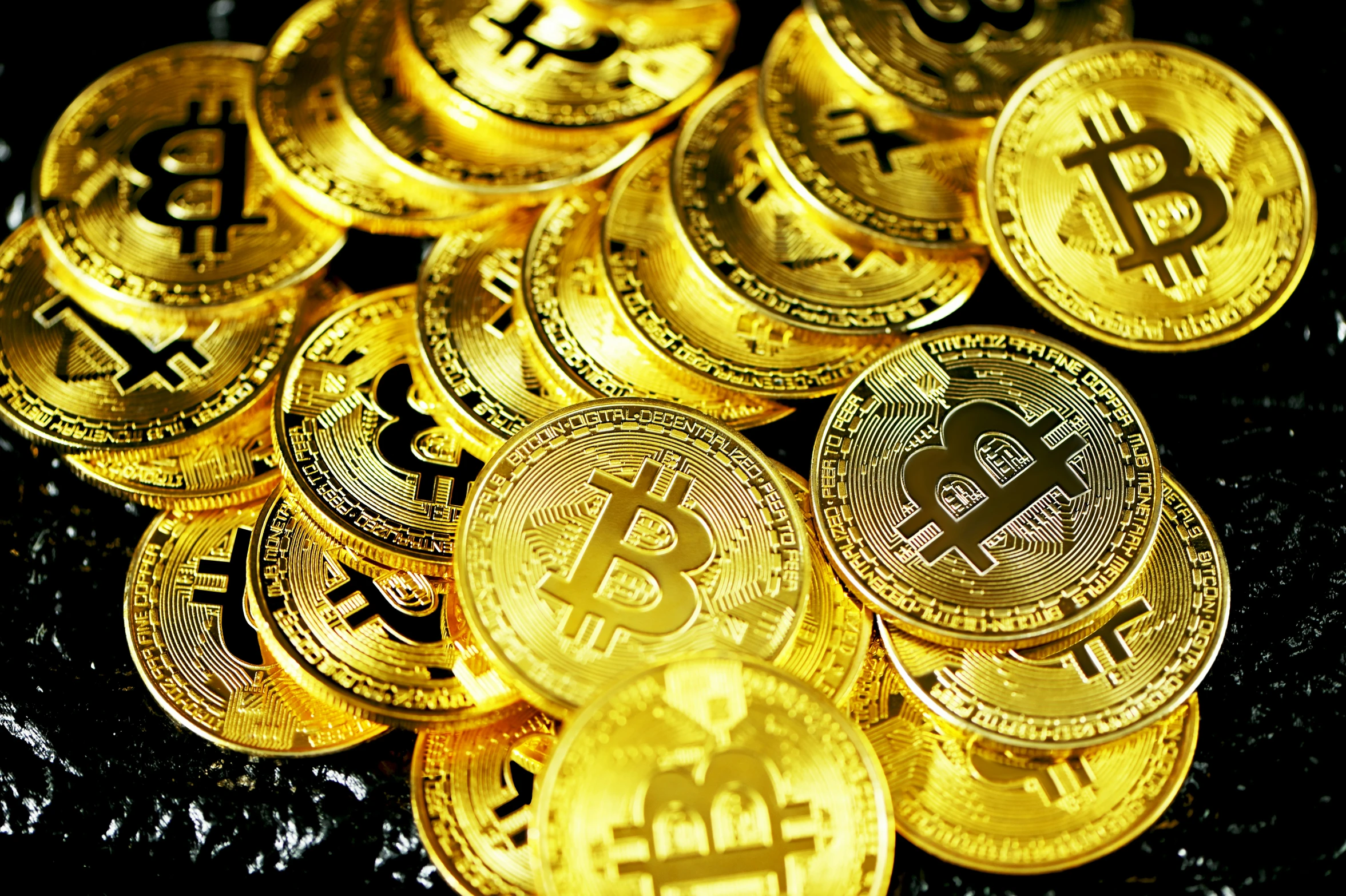 several piles of golden bitcoins are shown