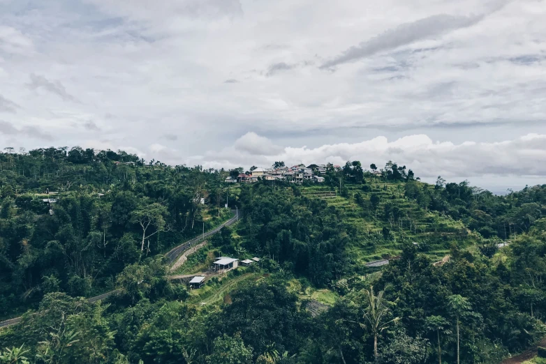 a very scenic view of a hill with houses in the distance