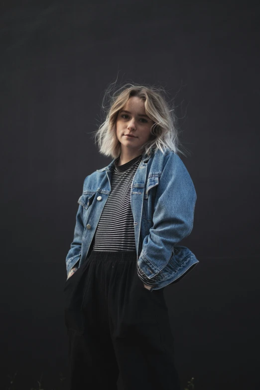 a blonde girl in a black and white top and black pants