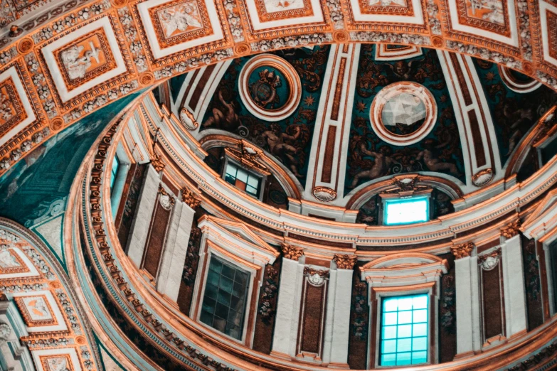 the ceiling of the ornate dome of the cathedral is painted white and brown