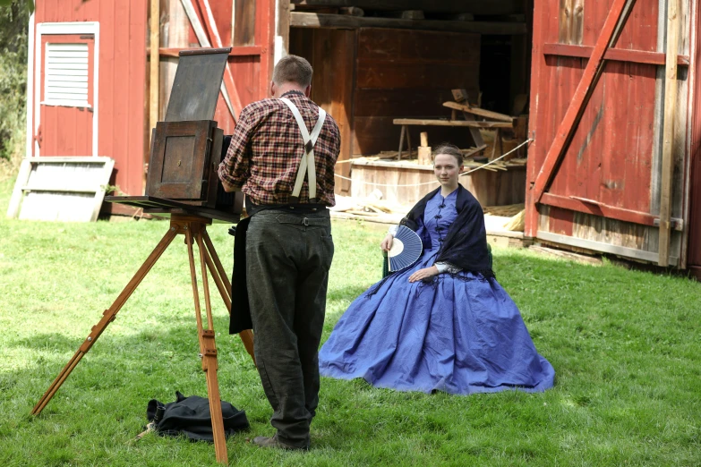 the man and woman are holding onto old camera