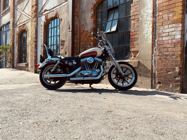 a blue motorcycle parked in front of a brick building