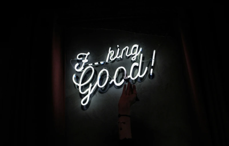 the neon sign reads if being good it is lit up