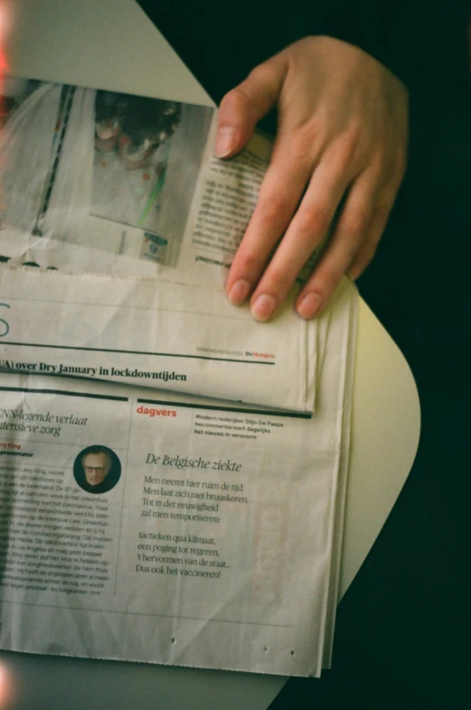 the hands of a person on top of a paper