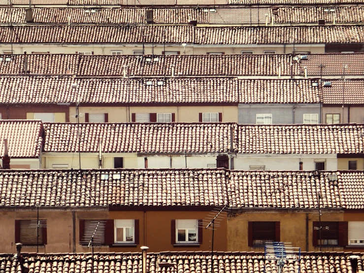 a building with lots of metal windows and shutters