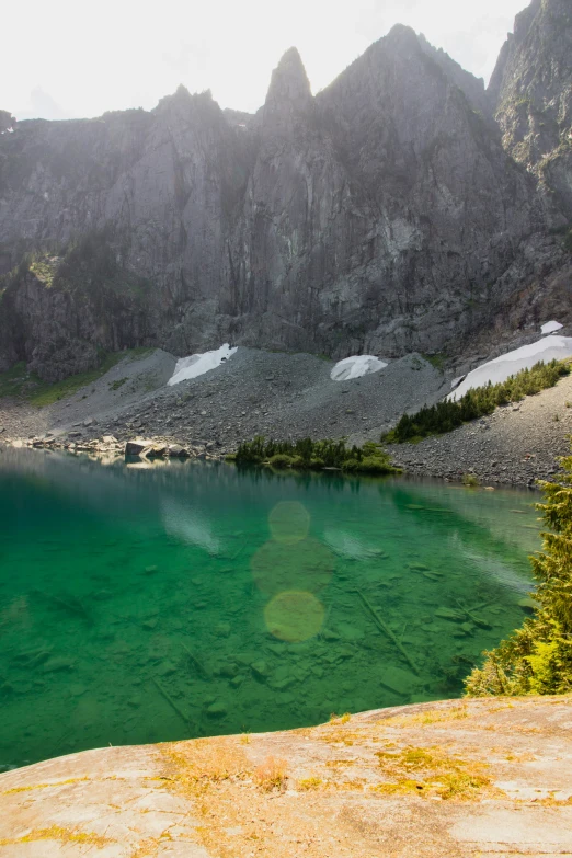 a man standing near the side of a lake