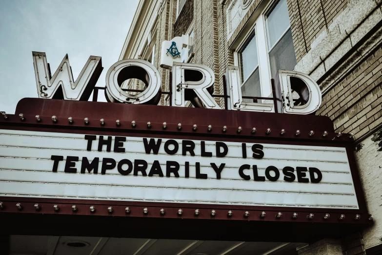 an old sign is advertising the world is temporary closed