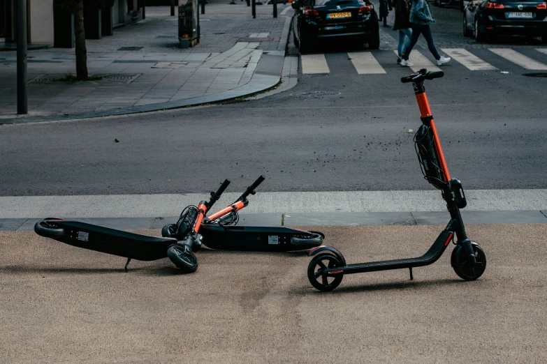 a scooter parked near a city street on the sidewalk